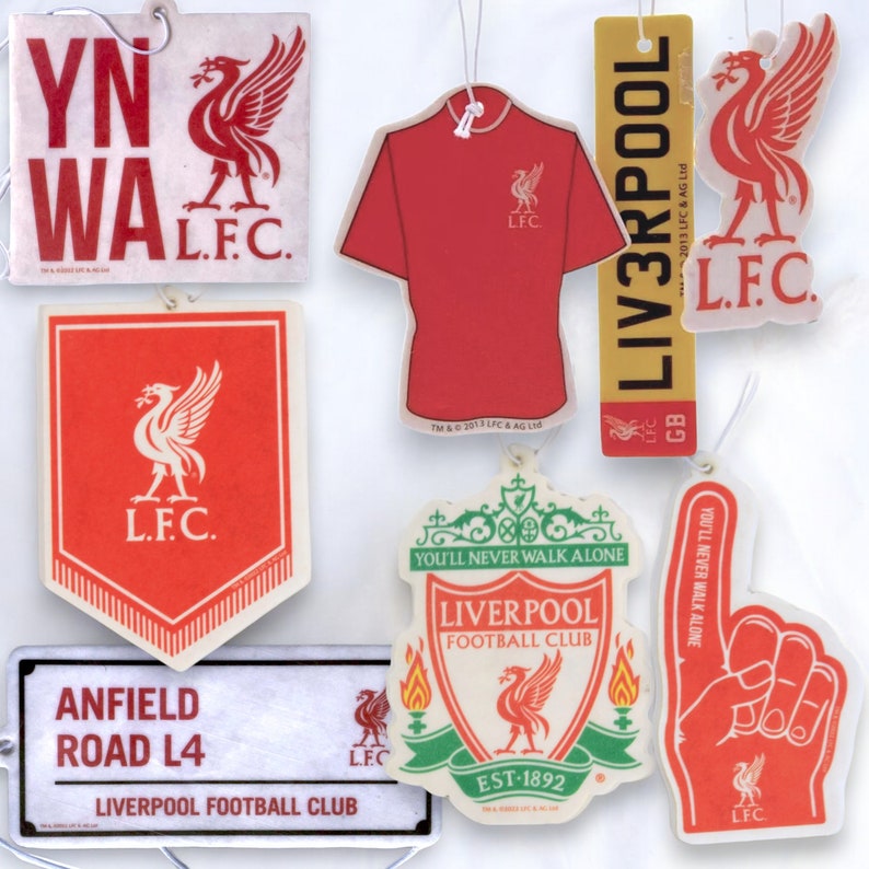 May include: A set of eight car air fresheners featuring the Liverpool Football Club logo. The air fresheners are in various shapes and sizes, including a jersey, a crest, and a finger.