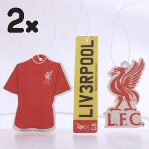 May include: Two car air fresheners featuring the Liverpool Football Club logo. One is a red jersey, one is a yellow rectangle with the text "LIV3RPOOL" and the other is a white bird with the text "L.F.C."