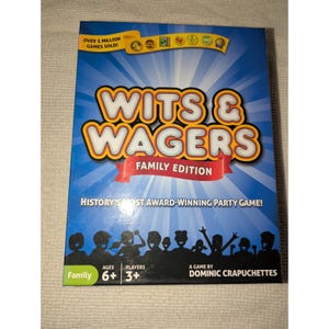 Könnte beinhalten: Eine blaue Box für das Spiel "Wits & Wagers Family Edition". Die Box zeigt den Titel des Spiels in großen gelben und orangefarbenen Buchstaben. Die Box enthält auch den Text "Over 1 Million Games Sold!" und "History's Most Award-Winning Party Game!"
