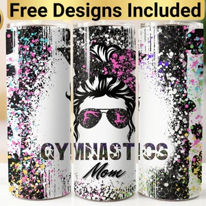 May include: A white tumbler with a black and white graphic of a woman with a messy bun and sunglasses. The graphic also includes the words "Gymnastics Mom" and a colorful splatter paint design.