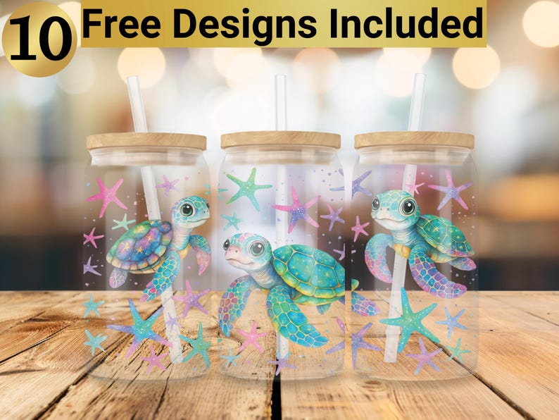 May include: Three clear glass tumblers with lids and straws. Each tumbler features a different design of a sea turtle with a colorful shell and a pink, blue, and green background. The tumblers are decorated with starfish and other ocean-themed designs.