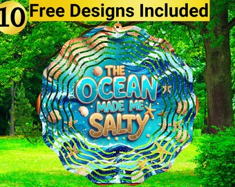 May include: A round, ocean-themed design with the text "The Ocean Made Me Salty." The design features seashells, starfish, and wavy blue lines. The top of the design has the text "10 Free Designs Included" in a yellow banner.