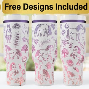 May include: Three stainless steel tumblers with a white background and a purple rim. The tumblers feature a repeating pattern of horses, flowers, and leaves in a gradient of pink and purple.
