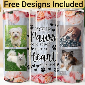 May include: A cylindrical tumbler featuring a rustic wood-grain background, pink floral accents, and four photographs of dogs. The text reads: YOUR Paws were ready BUT My Heart was not. Black paw prints and heart icons are scattered across the design.