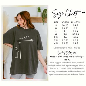 May include: An olive green t-shirt with a size chart. The chart lists measurements in inches for sizes S through 4XL. The shirt is made of ringspun cotton and has a ribbed collar and double-needle stitching.