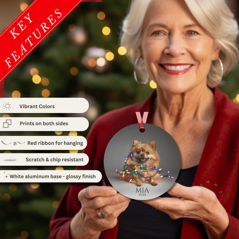 Round Christmas ornament.  Ornament has a Pomeranian wrapped in colorful Christmas lights.  Mia 2024 is at the bottom of the ornament.  Key features: vibrant colors, print on both sides, red ribbon for hanging, scratch & chip resistant, white aluminum base-glossy finish.