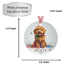 Round aluminum Christmas ornament.  The ornament has a Cavapoo wrapped in colorful Christmas lights.  At the bottom is Molly 2025.  Height 3.5", Width 3.5" and Depth 0.03"