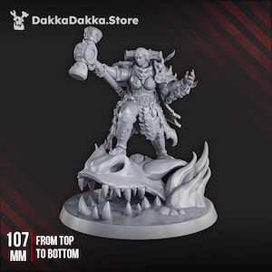May include: A gray miniature figurine of a warrior woman holding a hammer, standing on a dragon skull base. The figurine is 107 mm tall. The DakkaDakka.Store logo is in the top left corner.