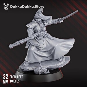 May include: A gray figurine of a warrior in a flowing robe, holding a sword and a staff. The figurine is standing on a rock, with a severed head at its base. The text "32 mm from feet to eyes" is visible. The DakkaDakka.Store logo is in the top left corner.