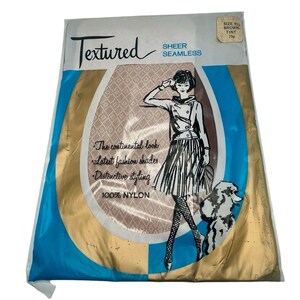 May include: A packet of Textured Sheer Seamless nylon tights in brown tint. The packet features a woman wearing the tights and a dog. The text on the packet reads "Textured Sheer Seamless", "The continental look", "Latest fashion shades", "Distinctive styling", "100% Nylon", "Size 91/2 Brown Tint 79".