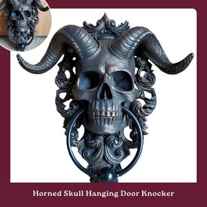 May include: A black metal horned skull hanging door knocker with intricate details. The skull has a realistic design with horns and a detailed face.