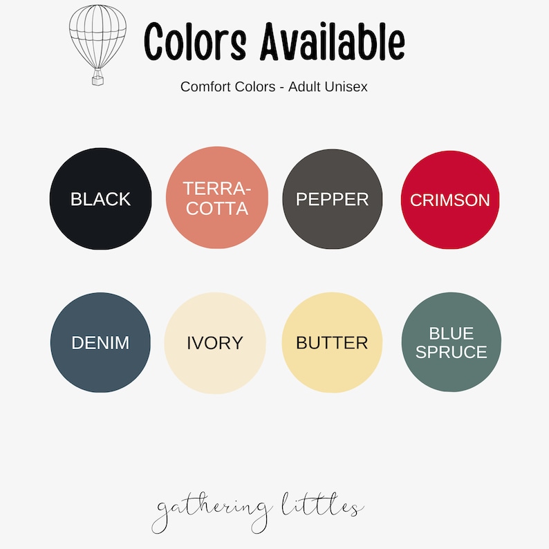 May include: Image displaying a color chart for Comfort Colors adult unisex apparel. The chart features eight circular color swatches: black, terracotta, pepper, crimson, denim, ivory, butter, and blue spruce. A hot air balloon illustration is in the upper left corner.