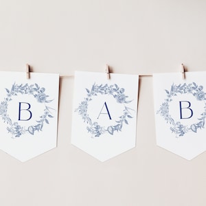 May include: A blue and white floral banner with the letters "B A B" in a navy blue font.