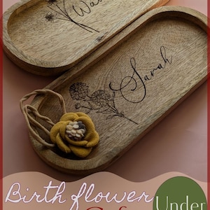 May include: Two wooden oval trays with engraved names "Waverly" and "Sarah" and floral designs. The trays are part of a set of birth flower gifts under $20.