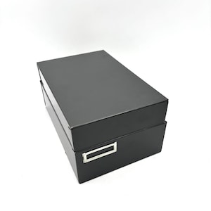 May include: A set of three ceramic mugs with a speckled, matte finish. The mugs are in shades of cream, light gray, and dark gray. Each mug has a simple, minimalist design and a rounded handle. The mugs are suitable for coffee, tea, or other beverages.