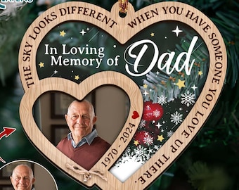 May include: Wooden heart-shaped Christmas ornament with a photo frame and the text "The sky looks different when you have someone you love up there. Dad. In loving memory of 1970-2024".