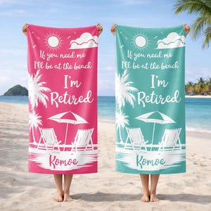 May include: Two beach towels, one pink and one teal, are held up on a sandy beach. Each towel has the text "If you need me I'll be at the beach, I'm Retired" with beach-themed graphics and the name "Komoe".