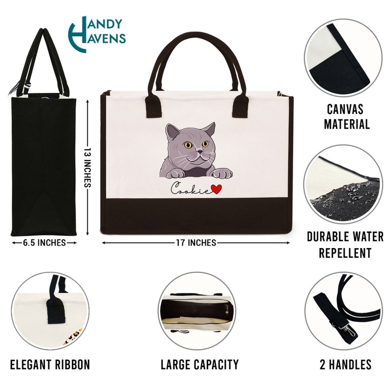 K&ouml;nnte beinhalten: Eine schwarze Canvas-Tragetasche mit braunem Boden. Die Tasche zeigt eine graue Katzenillustration mit dem Namen "Cookie" und einem roten Herzen. Die Tasche ist 43 cm breit und 33 cm hoch. Sie hat zwei schwarze Henkel und ein gro&szlig;es Fassungsverm&ouml;gen.