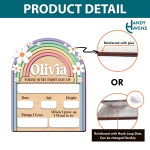 May include: A wooden rainbow-shaped growth chart with a pastel rainbow and white daisies. The chart has spaces to fill in the child's name, date, age, height, things they love, and what they want to be when they grow up. The text "Today is my first day of" is printed on the chart. The chart is reinforced with glue or hook and loop dots.