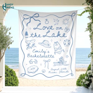 May include: A white fabric banner featuring blue line art illustrations of a champagne bottle, ring, sun, hat, bikini, lifebuoy, and boat. The text reads Love on the Lake, Emily's Bachelorette, and August 25th, Miami, Florida, framed by a blue border.
