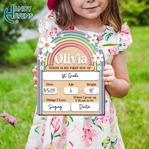 May include: A wooden sign with a rainbow and daisies, personalized with the name "Olivia". The sign says "Today is my first day of 1st Grade". It also includes the date "9/5/24", age "6", height "42", things I love "Singing", and when I grow up I want to be "Doctor".