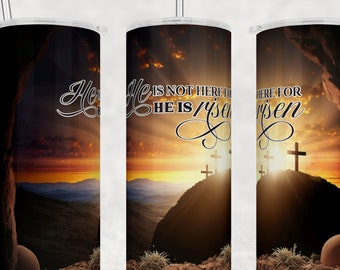 May include: A black and brown tumbler with a sunrise scene and the text "He is not here for He is risen".