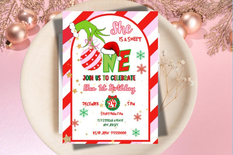 May include: A festive invitation for Elsa's 1st birthday, featuring a Grinch-themed design with a red and white striped border. The invitation includes the text "She is a sweet one" and event details. The invitation is on a white plate.