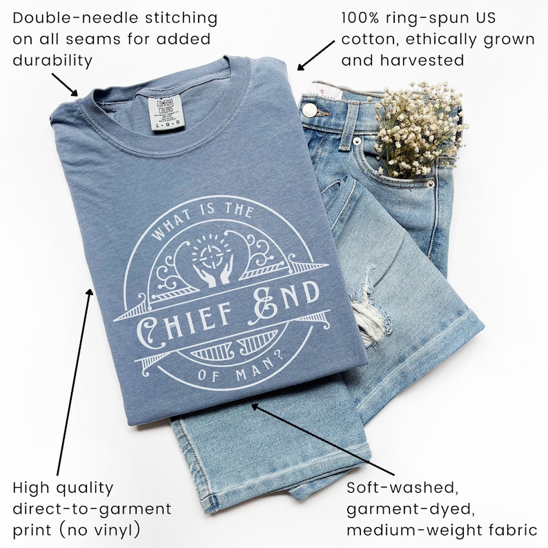 May include: A blue t-shirt with a white circle graphic that says "What is the Chief End of Man?" The shirt is made of 100% ring-spun US cotton and features double-needle stitching on all seams.