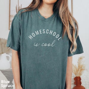 May include: A teal blue t-shirt with the text "HOMESCHOOL is cool" in white.