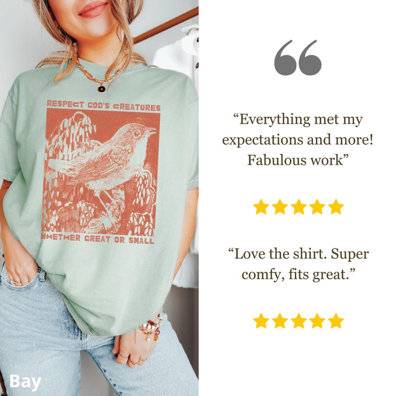 May include: A pale green t-shirt featuring an orange bird illustration and the text "RESPECT GOD'S CREATURES WHETHER GREAT OR SMALL". The shirt has a loose fit.