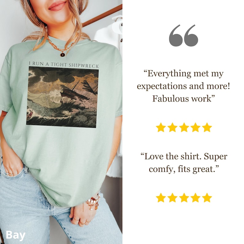 May include: A light green t-shirt with the text "I RUN A TIGHT SHIPWRECK" above a vintage illustration of a ship in a storm. The shirt is paired with light blue jeans.