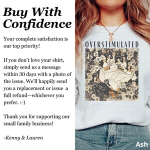 May include: Ash-colored sweatshirt with the word "OVERSTIMULATED" above a graphic of ducks and flowers. The text "Buy With Confidence" is on the left side of the image, along with a customer satisfaction guarantee.