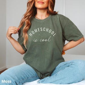 May include: A green t-shirt with the text "HOMESCHOOL is cool" in white lettering.