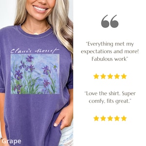 May include: Purple t-shirt with a painting of irises by Claude Monet. The shirt has a relaxed fit and a crew neck. The text "Claude Monet" is written in white above the painting.