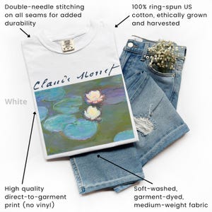 May include: White t-shirt featuring a Claude Monet painting of water lilies, paired with light-wash denim shorts. The shirt is made of 100% ring-spun US cotton and has double-needle stitching. The denim shorts have a distressed design.