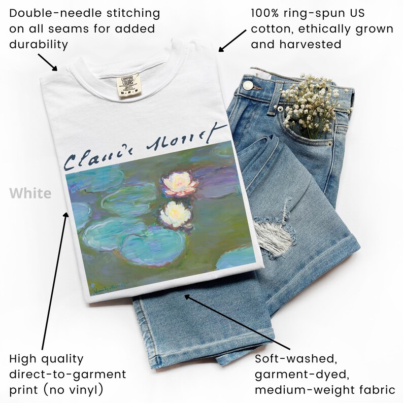 May include: White t-shirt featuring a Claude Monet painting of water lilies, paired with light-wash denim shorts. The shirt is made of 100% ring-spun US cotton and has double-needle stitching. The denim shorts have a distressed design.