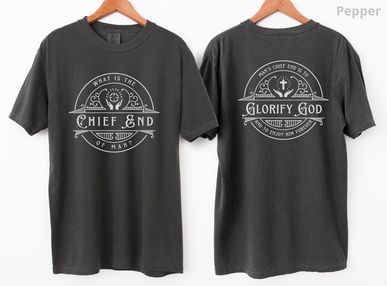 May include: A dark gray t-shirt with a white graphic on the front that reads "What is the Chief End of Man?" and a white graphic on the back that reads "Man's Chief End is to Glorify God and to Enjoy Him Forever."