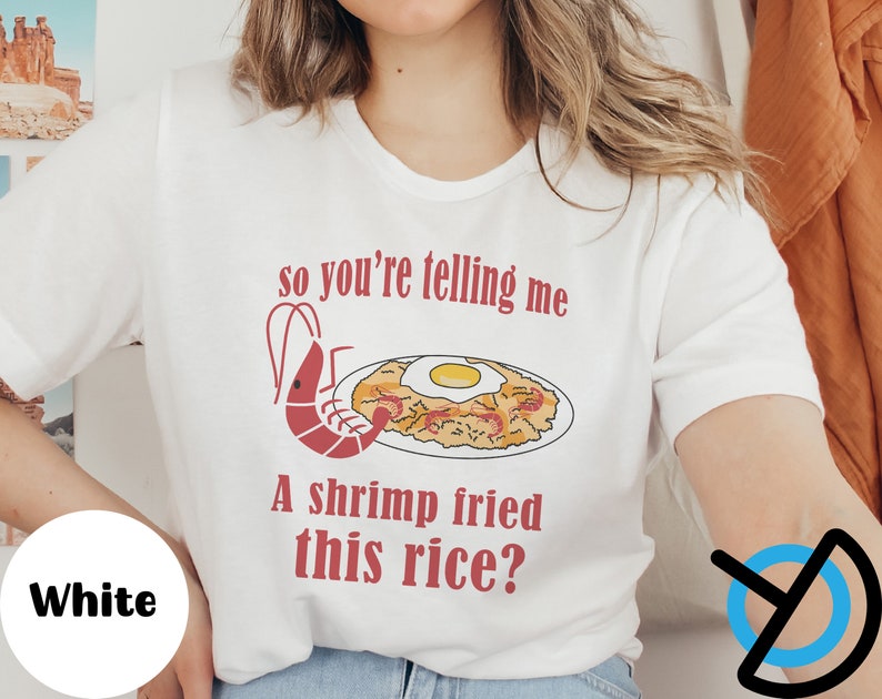 May include: White t-shirt with a red graphic of a shrimp and fried rice with the text "so you're telling me a shrimp fried this rice?"