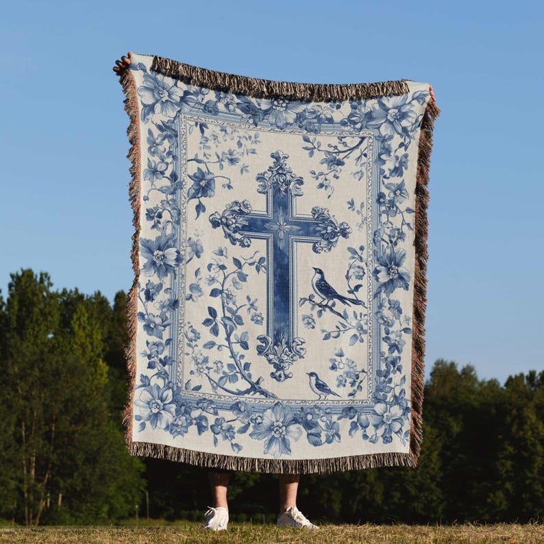 a blue and white blanket with a cross on it