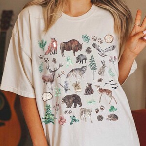 a woman wearing a t - shirt with animals on it