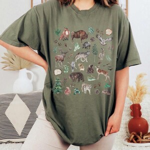 a woman wearing a t - shirt with animals on it