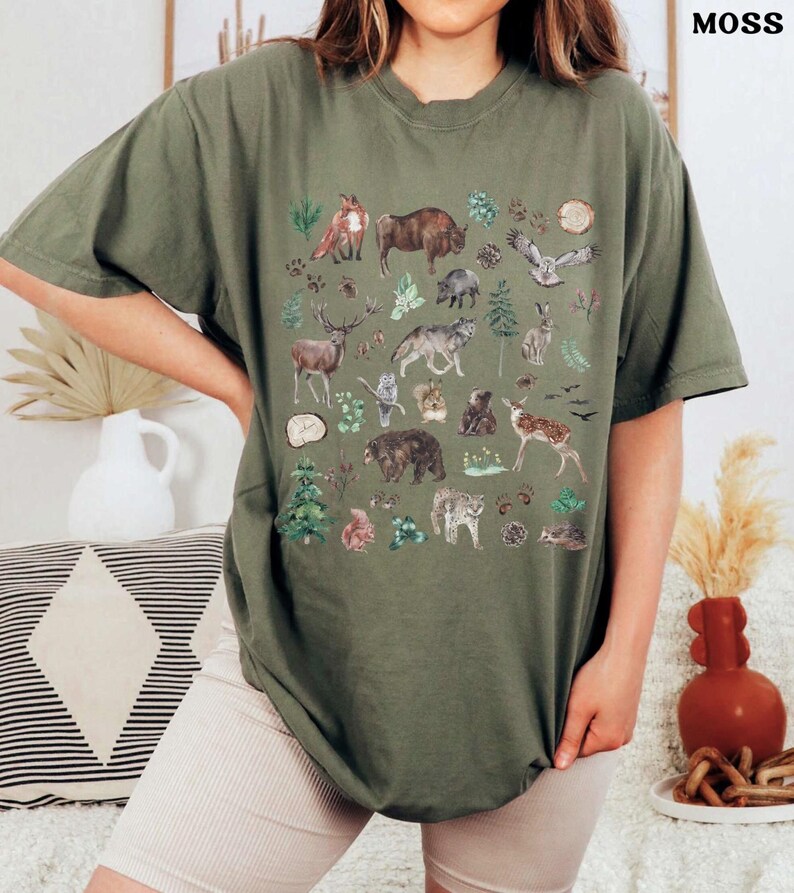 a woman wearing a t - shirt with animals on it