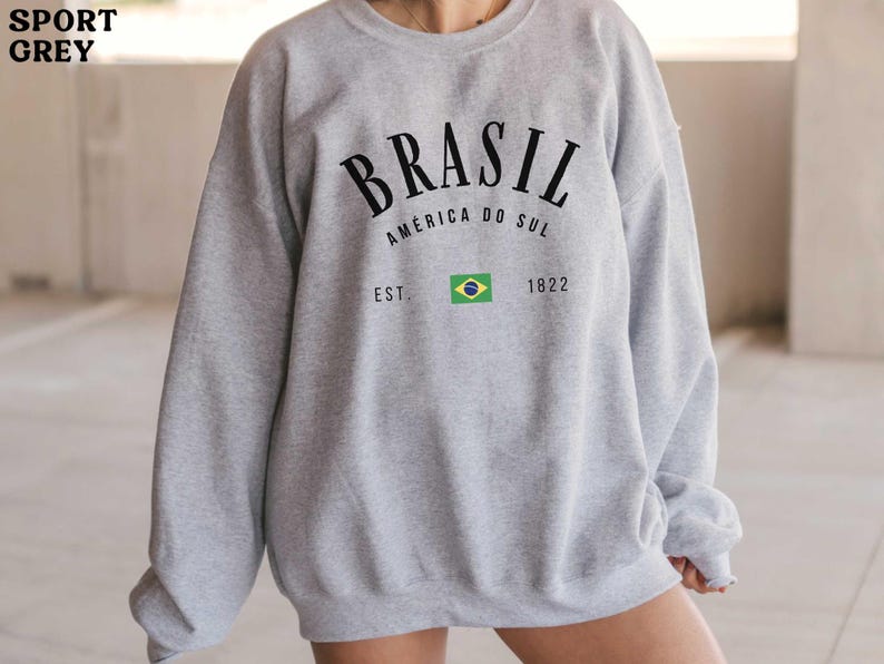 a woman wearing a gray sweatshirt and shorts
