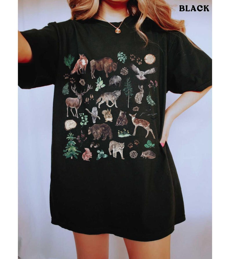 a woman wearing a black shirt with animals on it