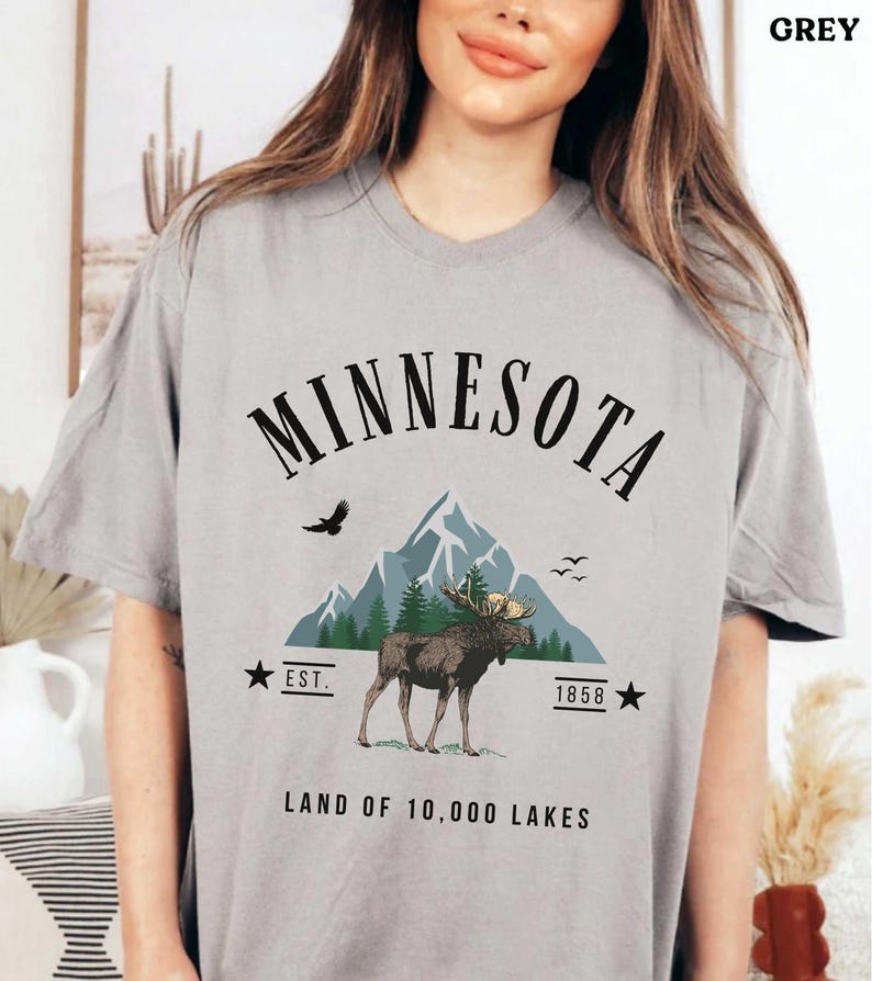 a woman wearing a minnesota t - shirt with a moose on it