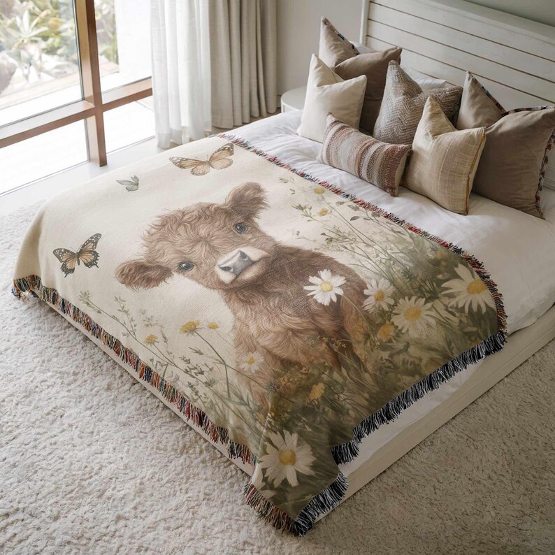 a cozy bedroom scene with a large bed adorned with a blanket featuring a cow surrounded by flowers and butterflies.