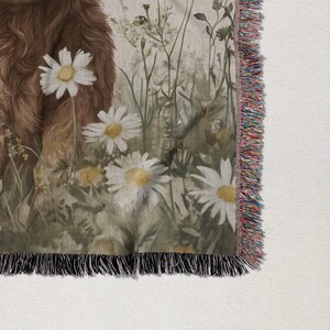 a close-up view of a floral print on a fabric, with a brown furry animal in the background.