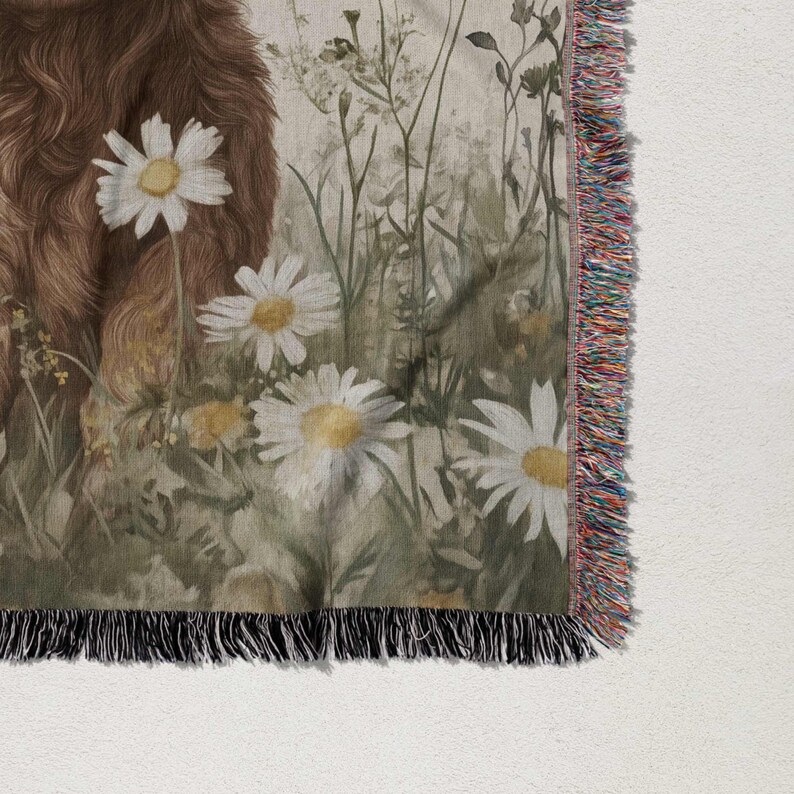 a close-up view of a floral print on a fabric, with a brown furry animal in the background.