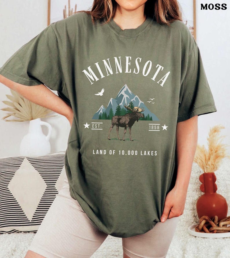 a woman wearing a minnesota t - shirt with a moose on it