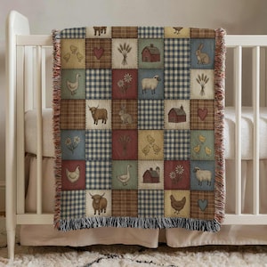 May include: A patchwork throw blanket with a farm animal theme. The blanket features squares with images of chickens, sheep, barns, and rabbits. The color palette includes blue, red, brown, and cream. The blanket has a fringed edge and is draped over a crib.